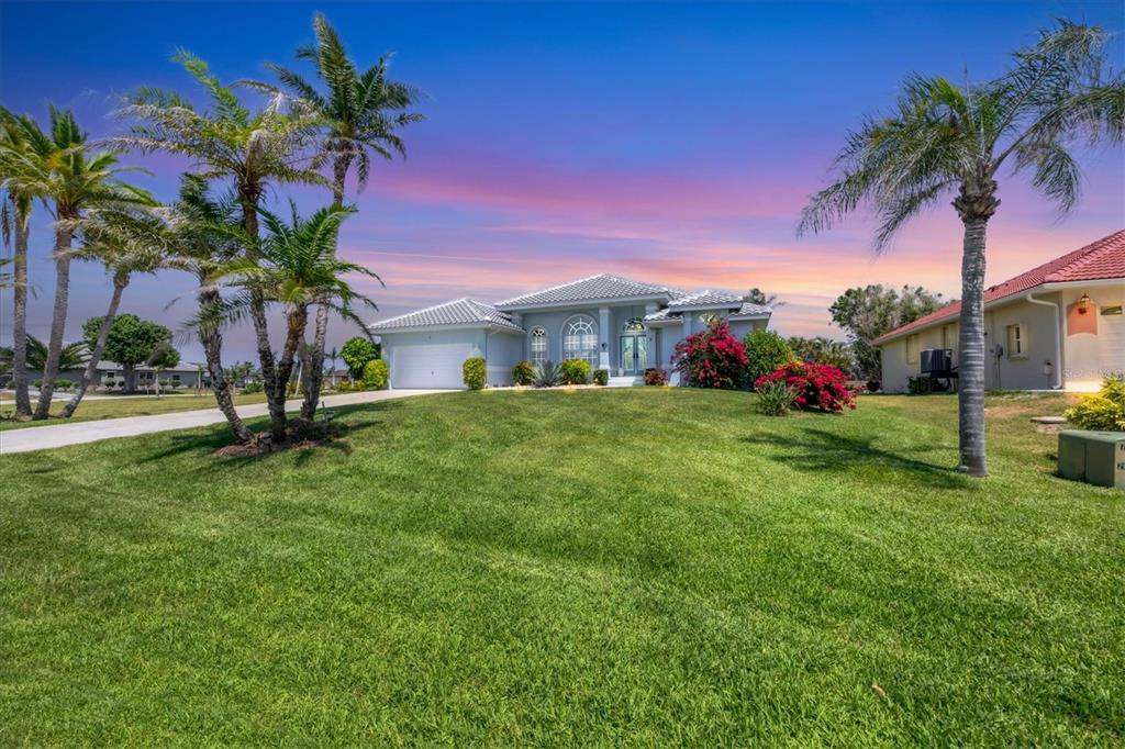 11 Amberjack Lane Placida, FL 33946 - Photo 6 of 46 a palm tree sitting in front of a house with a big yard