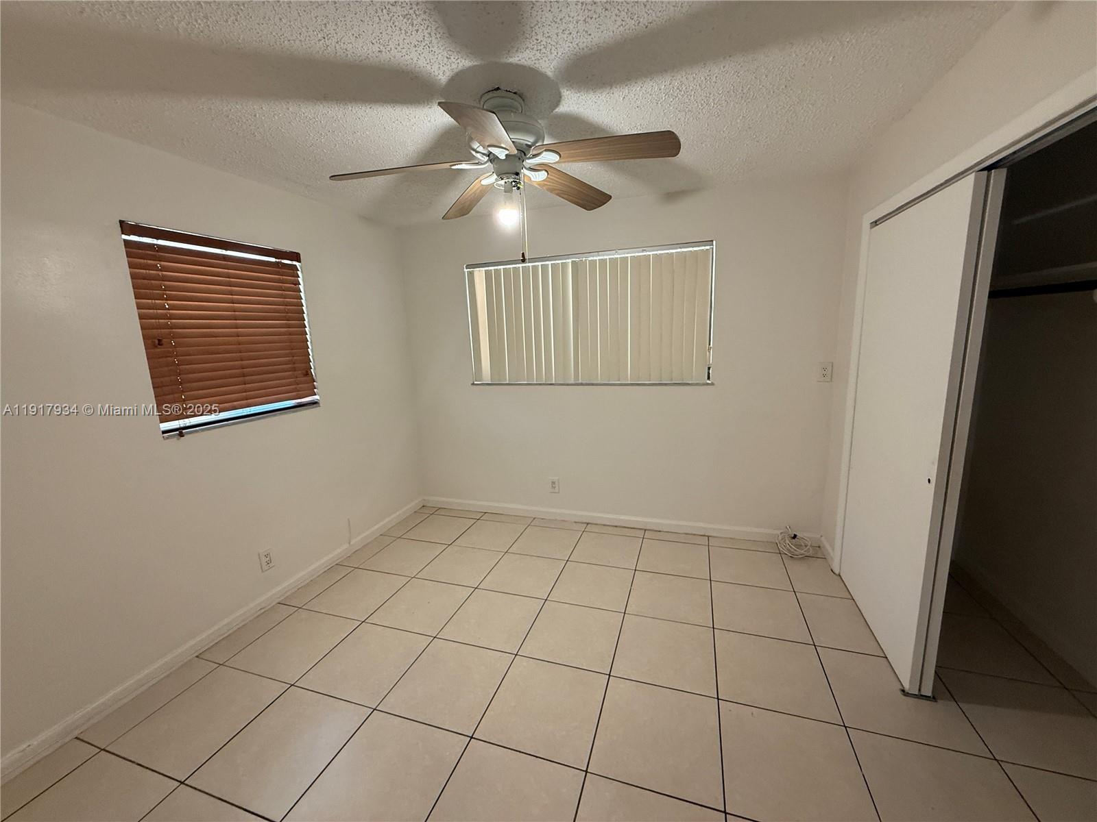 521 Southwest 9th Street, Unit 2 Hallandale Beach, FL 33009 - Photo 5 of 10 a view of an empty room with a window