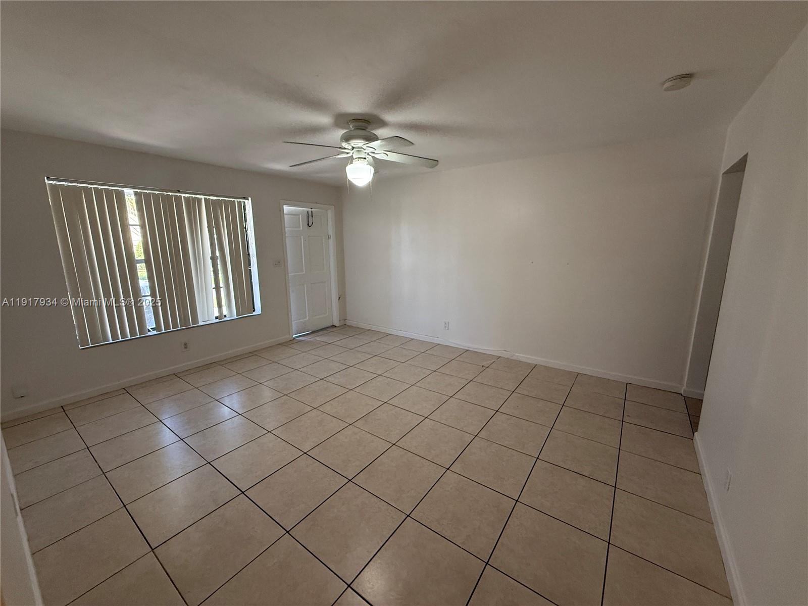 521 Southwest 9th Street, Unit 2 Hallandale Beach, FL 33009 - Photo 6 of 10 a view of an empty room and window
