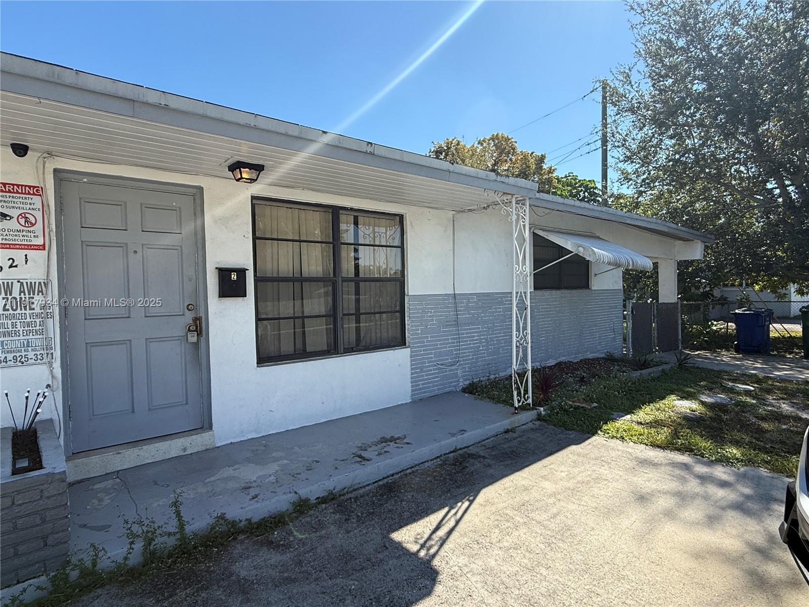 521 Southwest 9th Street, Unit 2 Hallandale Beach, FL 33009 - Photo 9 of 10 a view of a house with a yard