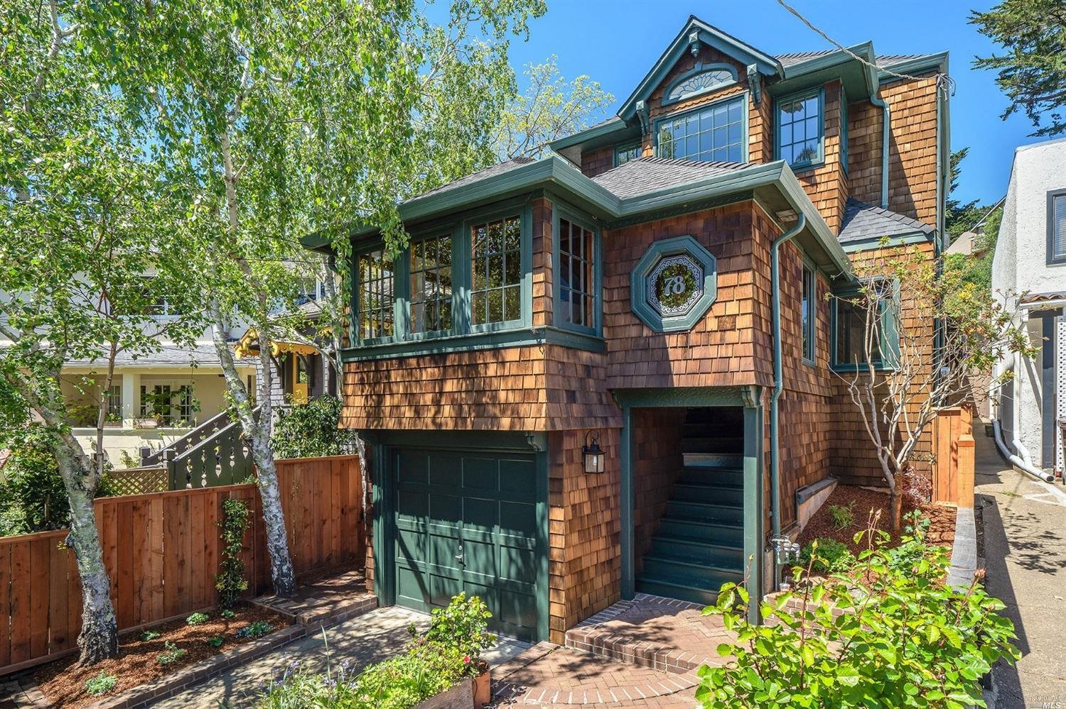 a front view of a house with garden