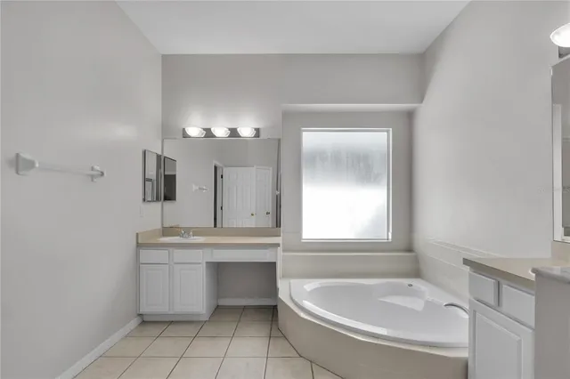 a bathroom with a double vanity sink mirror and shower