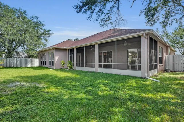 a view of a house with backyard and garden