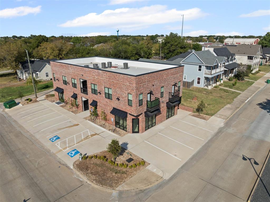 201 East 5th Street, Unit 201 Ferris, TX 75125 - Photo 2 of 19 a aerial view of a house with a yard