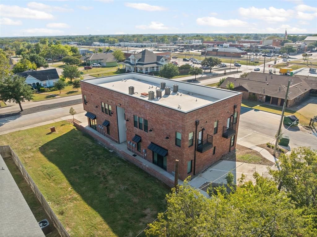 201 East 5th Street, Unit 201 Ferris, TX 75125 - Photo 4 of 19 an aerial view of a house with a garden