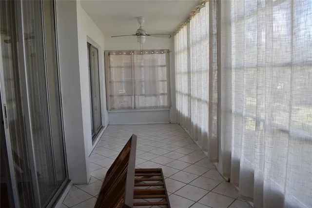 a hallway with windows and a chandelier
