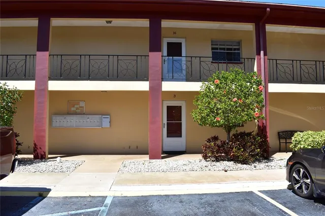 a view of a house with a bench in front of house