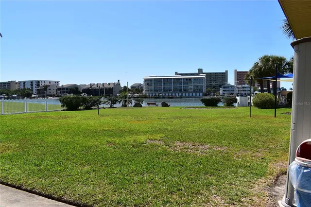a view of a house with a yard and potted plants