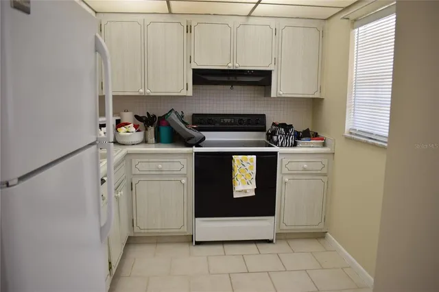 a kitchen with a stove top oven and cabinets