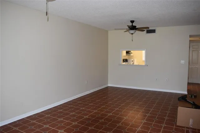 a view of a room with a fan and a window