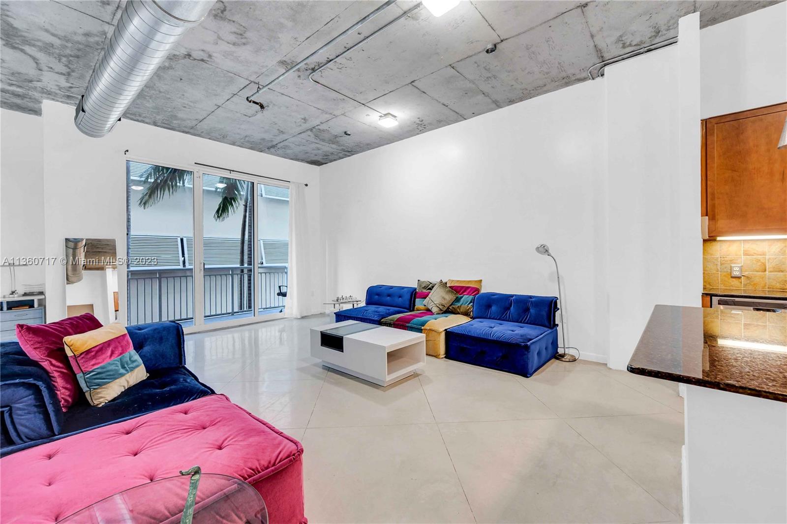 2001 Biscayne Boulevard, Unit 3207 Miami, FL 33137 - Photo 2 of 15 a living room with furniture and a flat screen tv