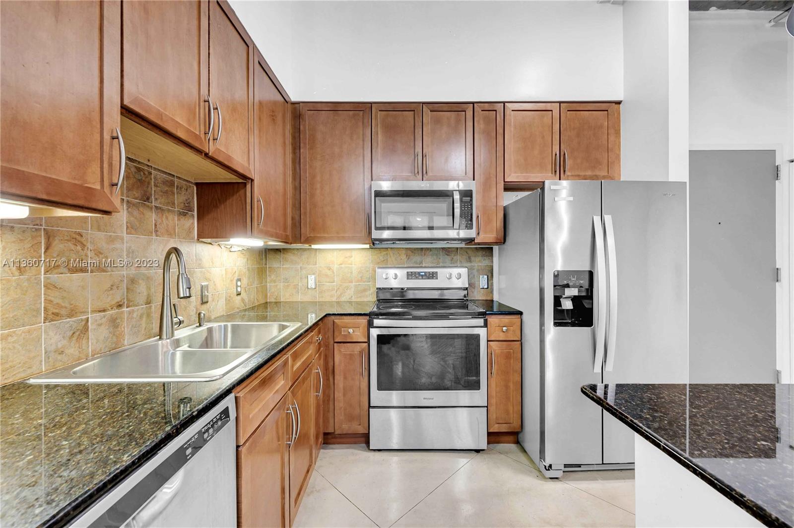2001 Biscayne Boulevard, Unit 3207 Miami, FL 33137 - Photo 3 of 15 a kitchen with stainless steel appliances granite countertop a sink stove and refrigerator