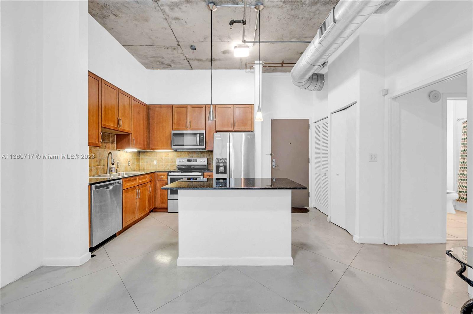 2001 Biscayne Boulevard, Unit 3207 Miami, FL 33137 - Photo 4 of 15 a large kitchen with cabinets and stainless steel appliances