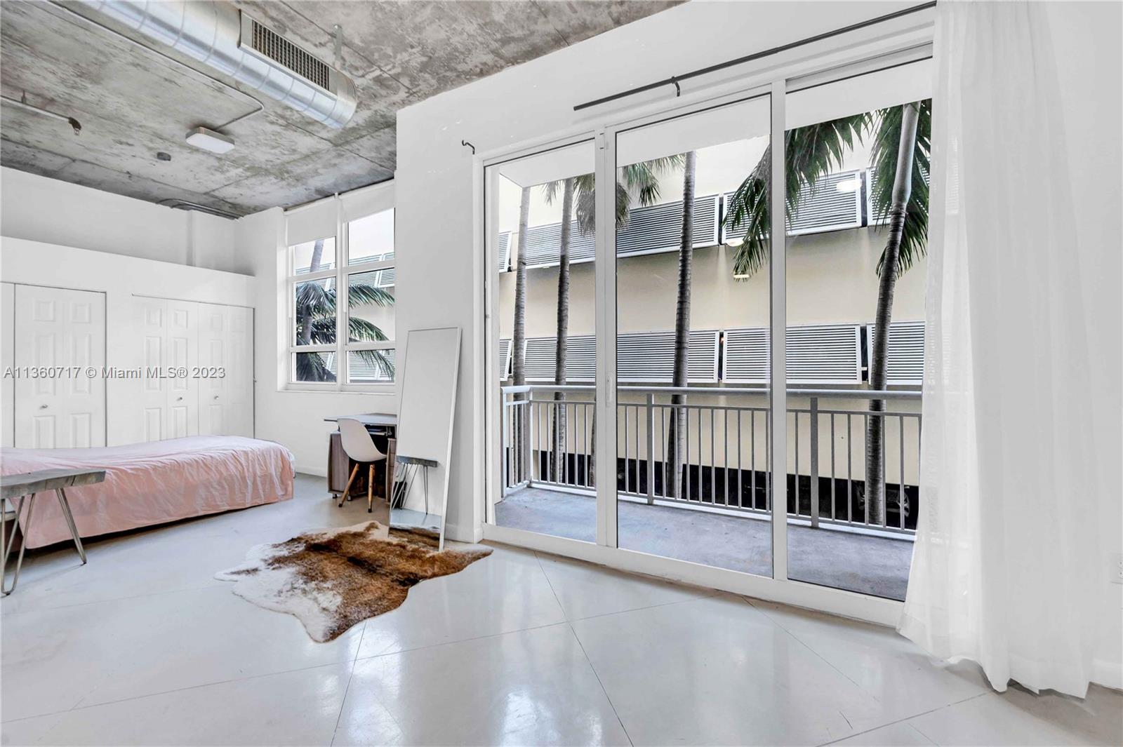 2001 Biscayne Boulevard, Unit 3207 Miami, FL 33137 - Photo 7 of 15 a bedroom with furniture and a window