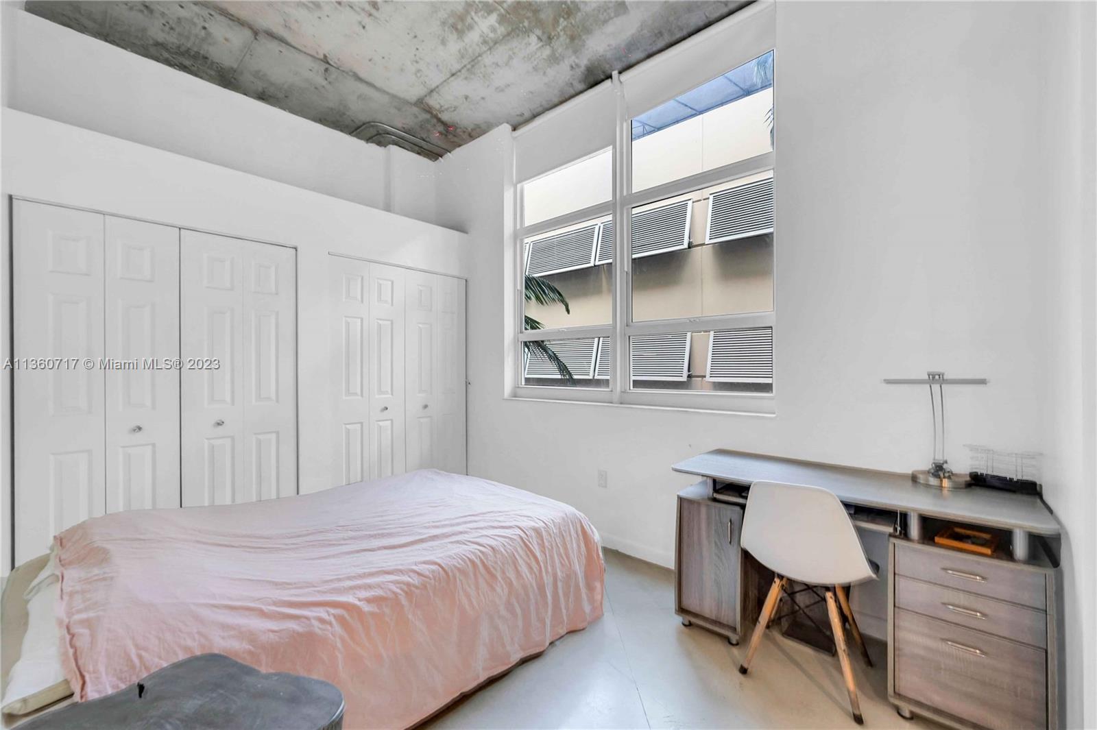 2001 Biscayne Boulevard, Unit 3207 Miami, FL 33137 - Photo 8 of 15 a bedroom with a bed and a chair with the wooden floor