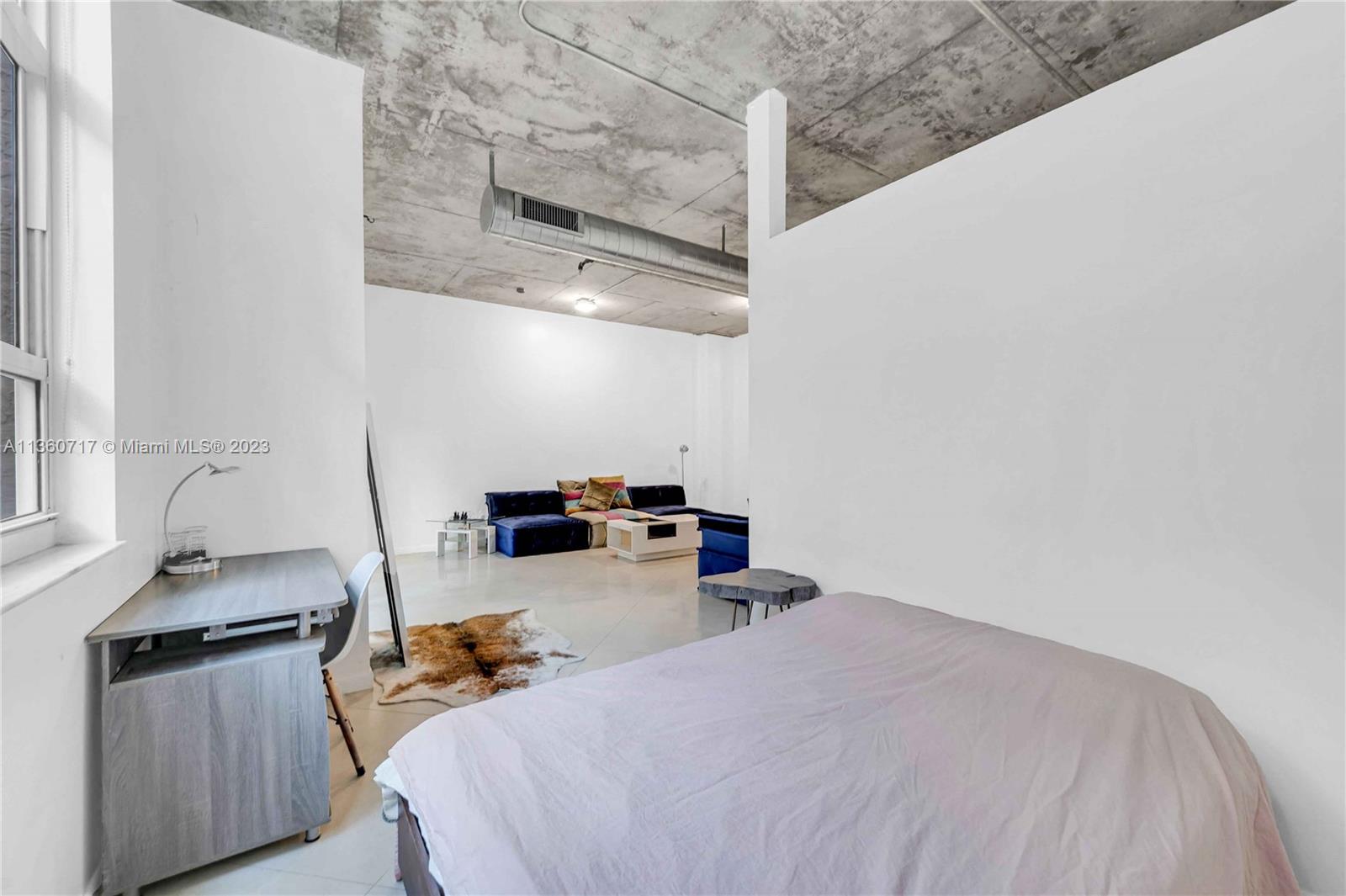 2001 Biscayne Boulevard, Unit 3207 Miami, FL 33137 - Photo 9 of 15 a bedroom with bed and cabinets