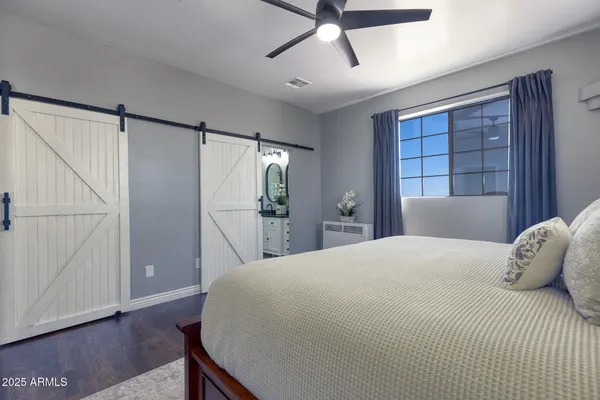 a bedroom with a bed and a window