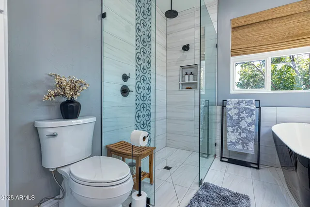 a bathroom with a toilet sink and shower