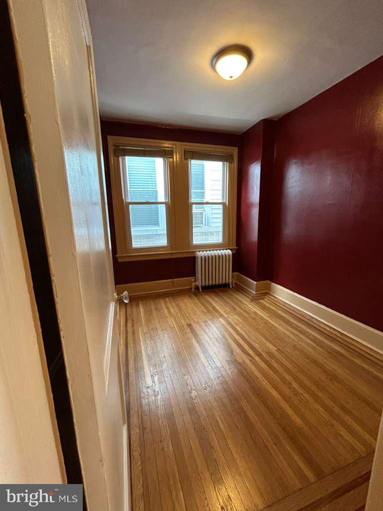 4747 Sansom Street Philadelphia, PA 19139 - Photo 14 of 21 an empty room with wooden floor and windows