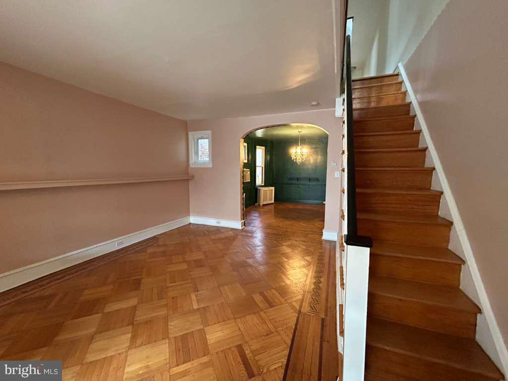 4747 Sansom Street Philadelphia, PA 19139 - Photo 5 of 21 a view of a hallway with wooden floor and staircase