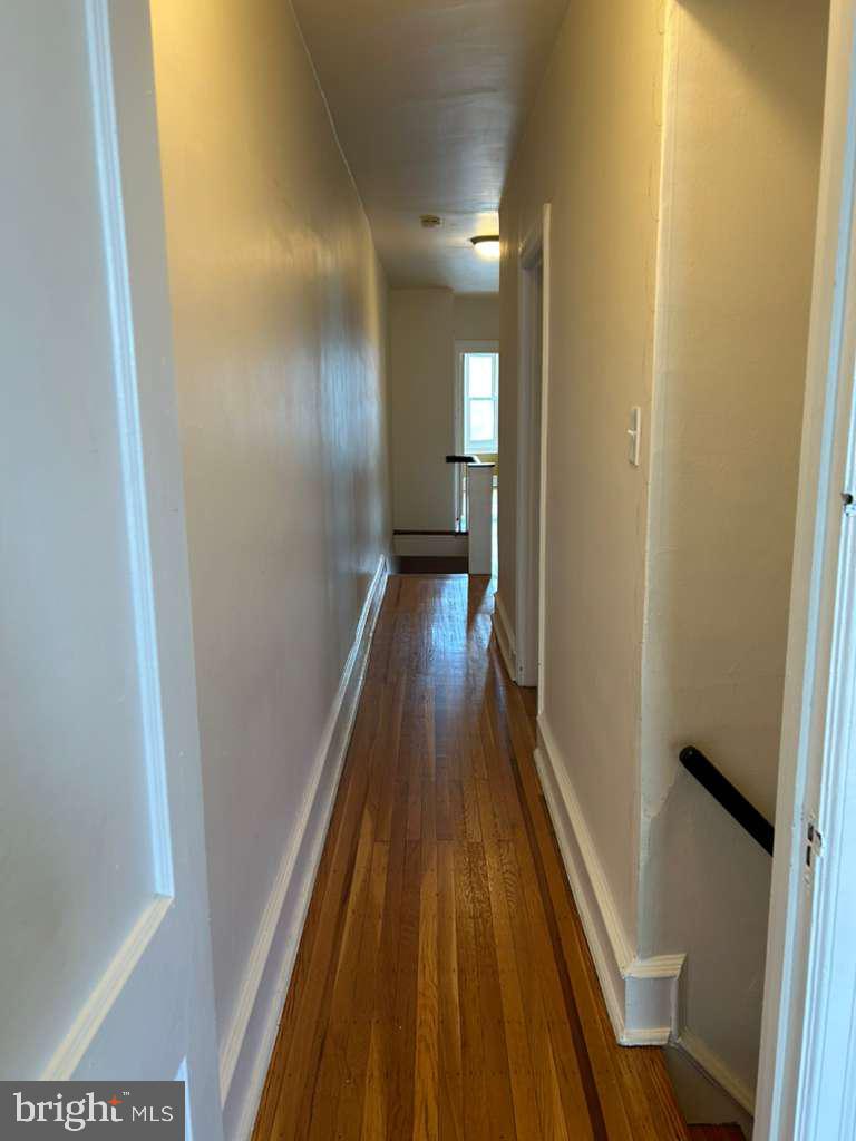 4747 Sansom Street Philadelphia, PA 19139 - Photo 10 of 21 a view of a hallway with wooden floor