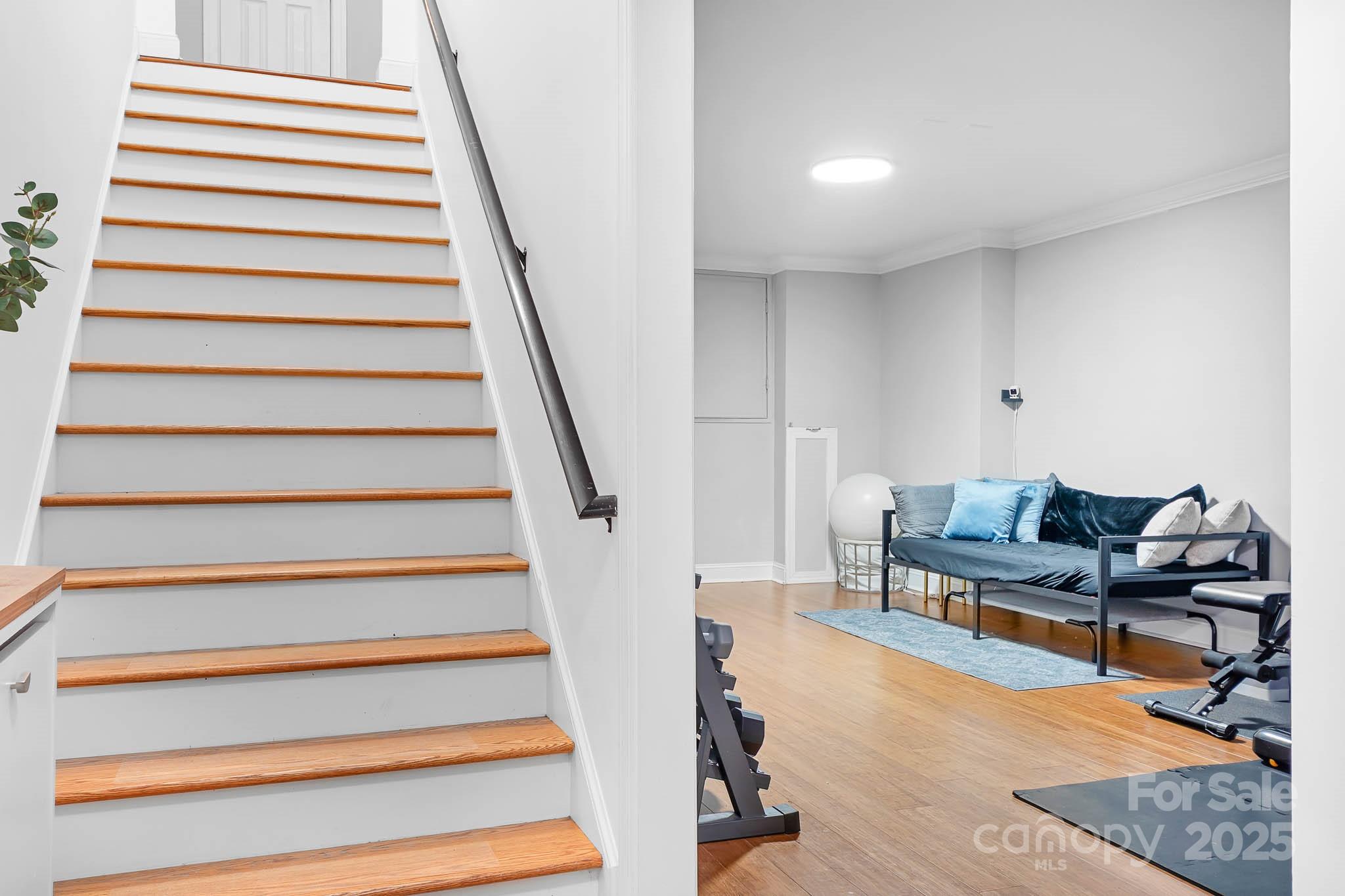 135 High Ridge Road Mooresville, NC 28117 - Photo 9 of 24 a living room with furniture and stairs