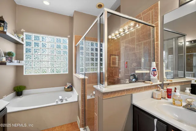 a bathroom with a tub a sink and a window