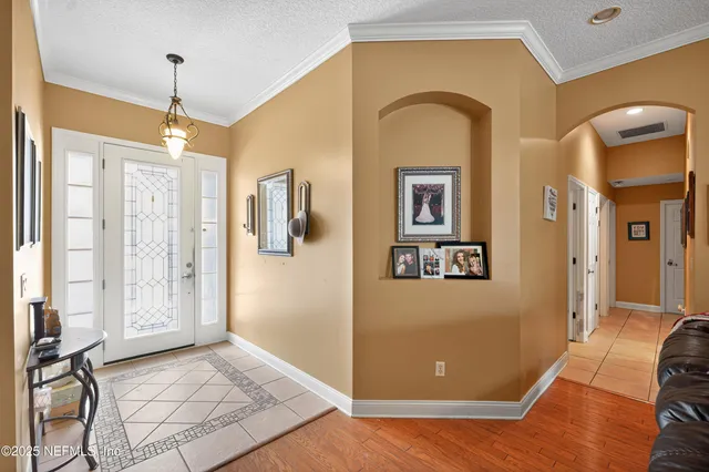 a view of a livingroom with wooden floor and furniture