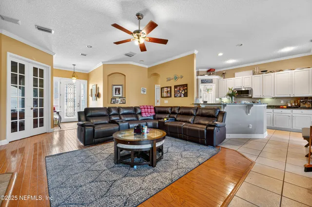 a living room with furniture and a kitchen view
