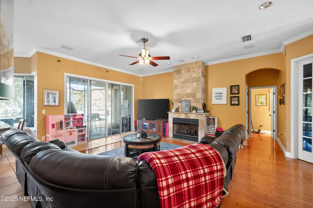 a living room with fireplace furniture and a flat screen tv