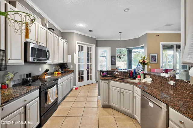 a kitchen with stainless steel appliances granite countertop a sink stove and cabinets