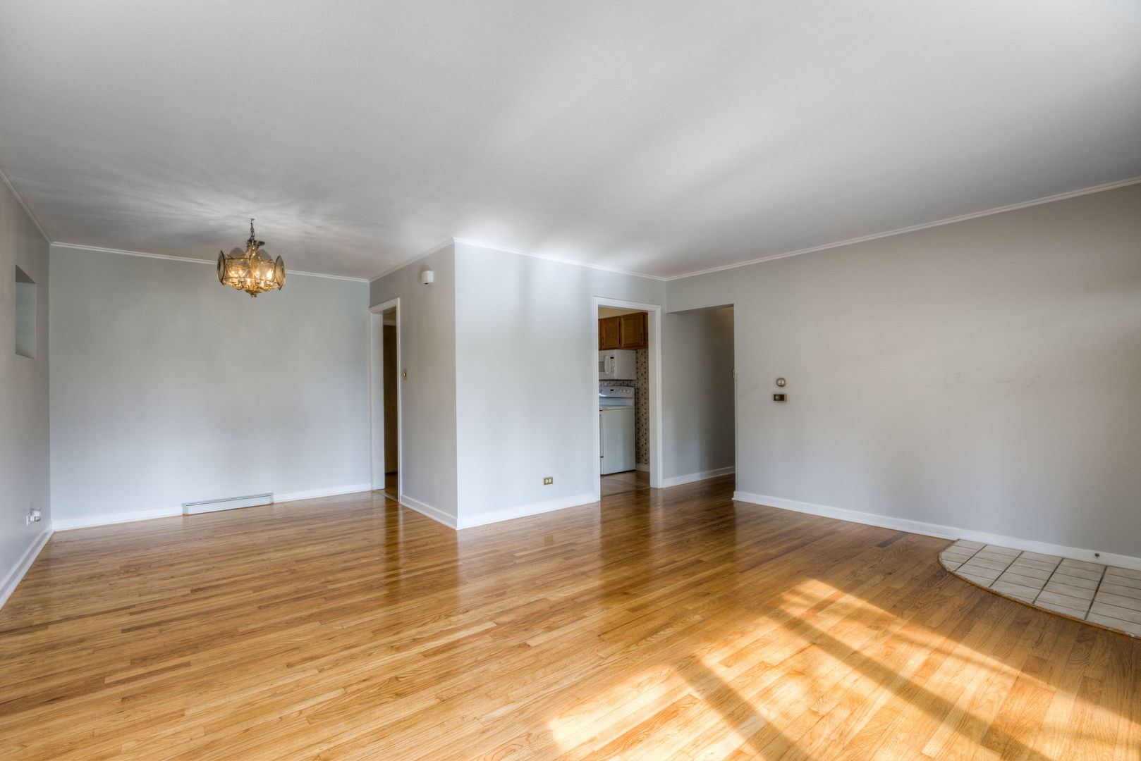 1046 Midway Road Northbrook, IL 60062 - Photo 5 of 24 a view of an empty room with wooden floor and a window