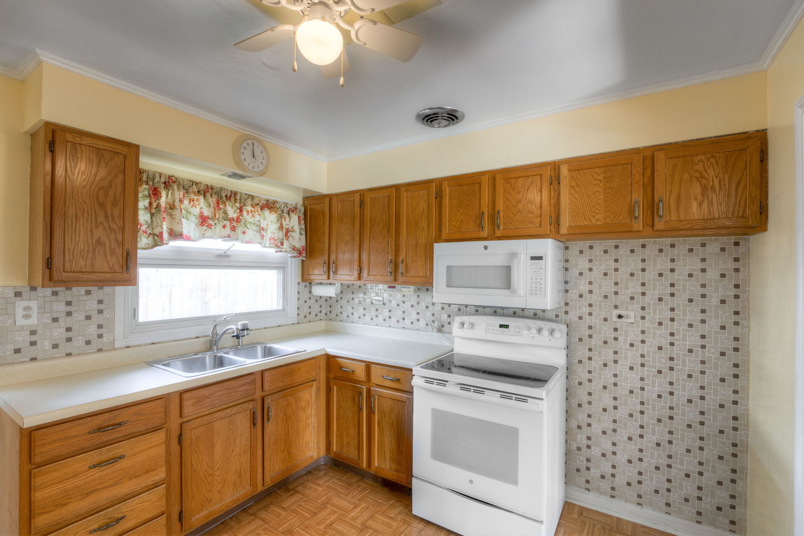1046 Midway Road Northbrook, IL 60062 - Photo 8 of 24 a kitchen with a sink a stove a microwave a refrigerator and cabinets