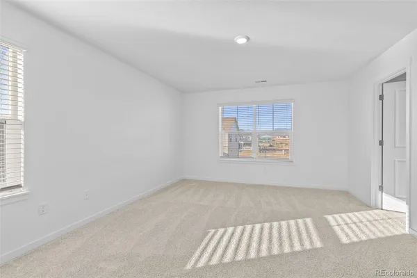 an empty room with a cabinet and mirror