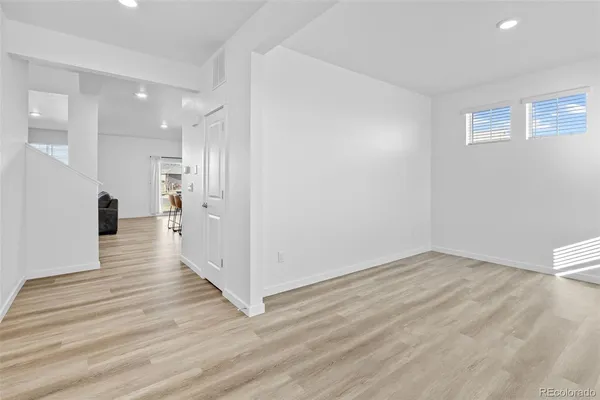 a view of wooden floor and windows in a room