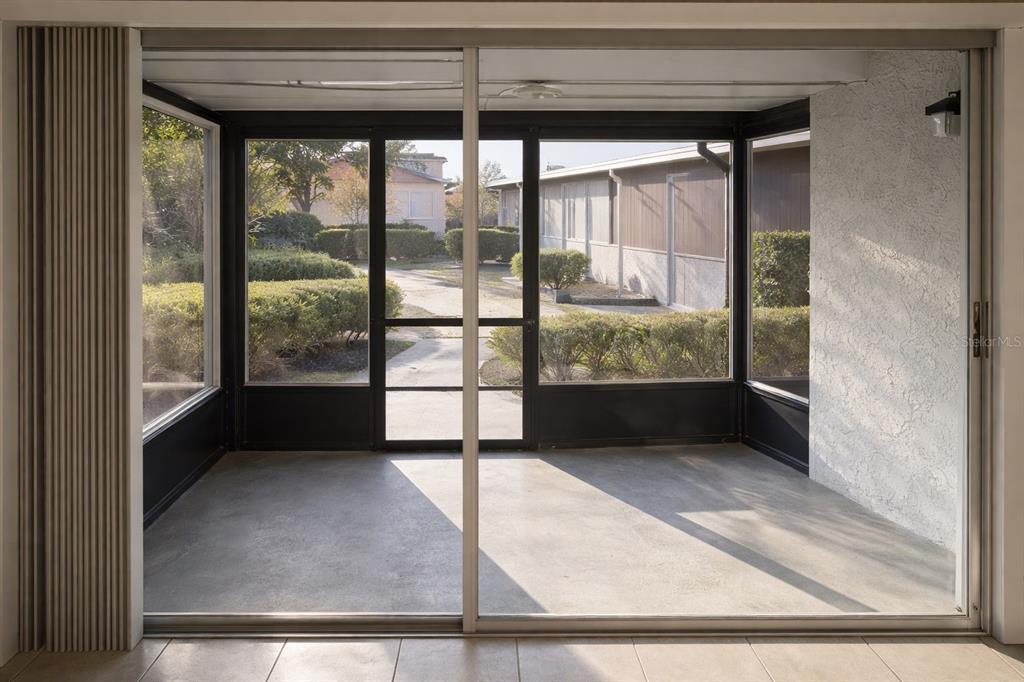2727 West Oak Ridge Road, Unit 2/ BLDG #7 Orlando, FL 32809 - Photo 13 of 13 a view of a glass door with a balcony