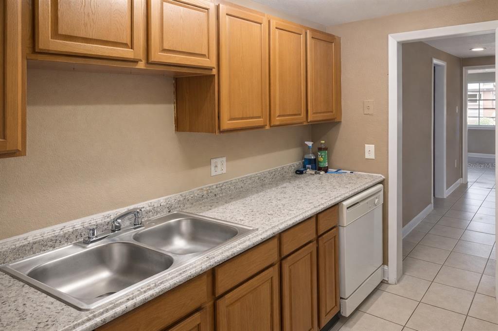 2727 West Oak Ridge Road, Unit 2/ BLDG #7 Orlando, FL 32809 - Photo 5 of 13 a kitchen with a sink cabinets and utility