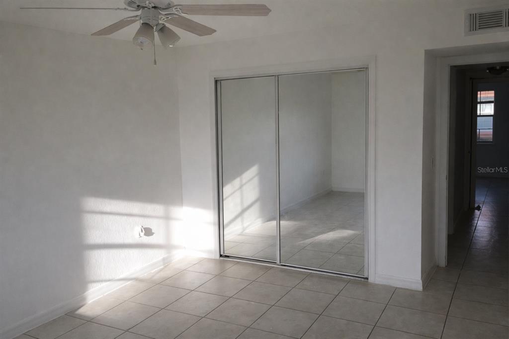 2727 West Oak Ridge Road, Unit 2/ BLDG #7 Orlando, FL 32809 - Photo 8 of 13 a view of an empty room and window chandelier fan