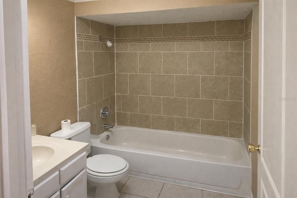 2727 West Oak Ridge Road, Unit 2/ BLDG #7 Orlando, FL 32809 - Photo 9 of 13 a bathroom with a sink a toilet and a bathtub