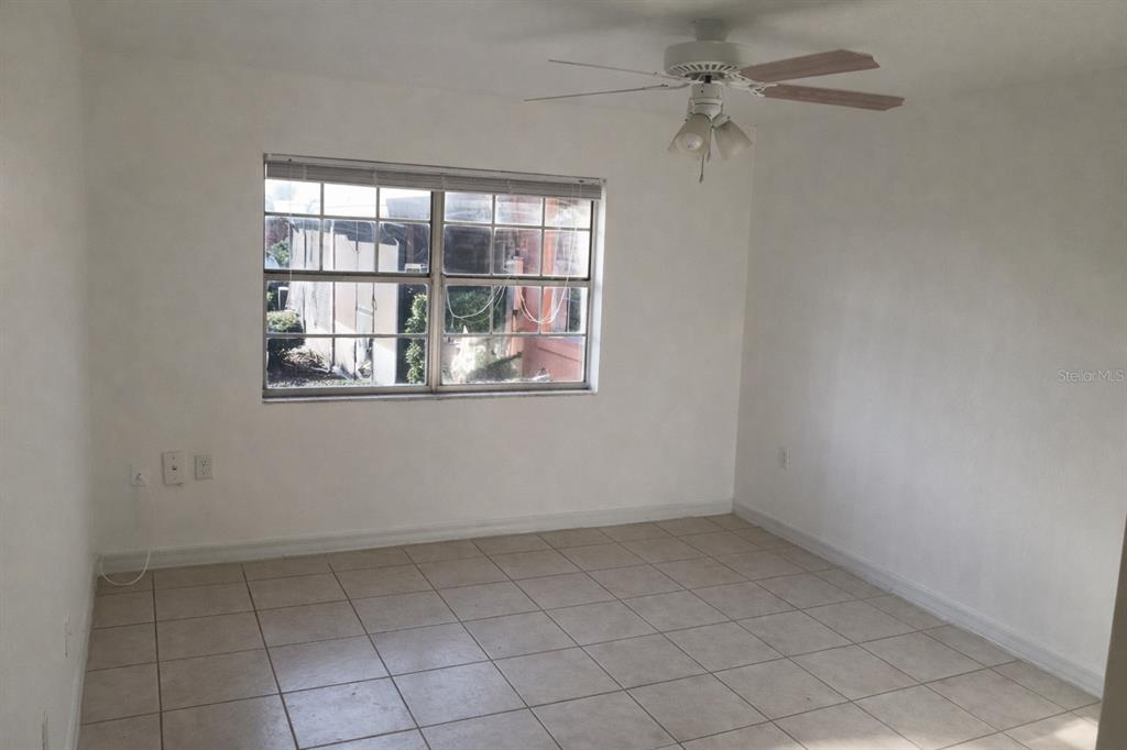 2727 West Oak Ridge Road, Unit 2/ BLDG #7 Orlando, FL 32809 - Photo 10 of 13 an empty room with a window