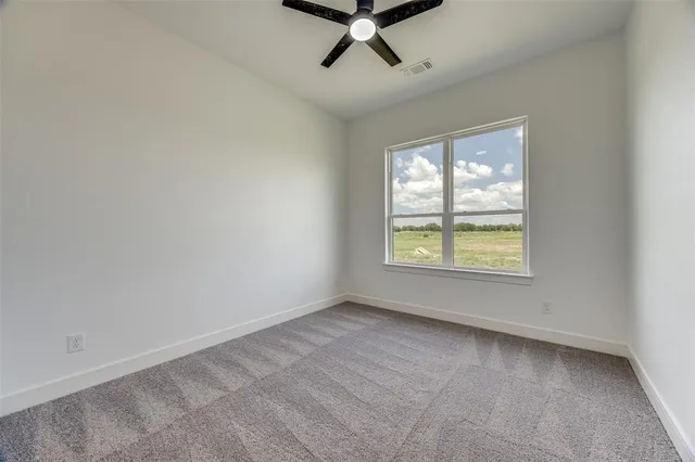 a front view of a house with a garden and plants