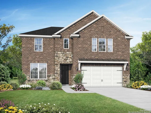 a front view of a house with a garden and yard