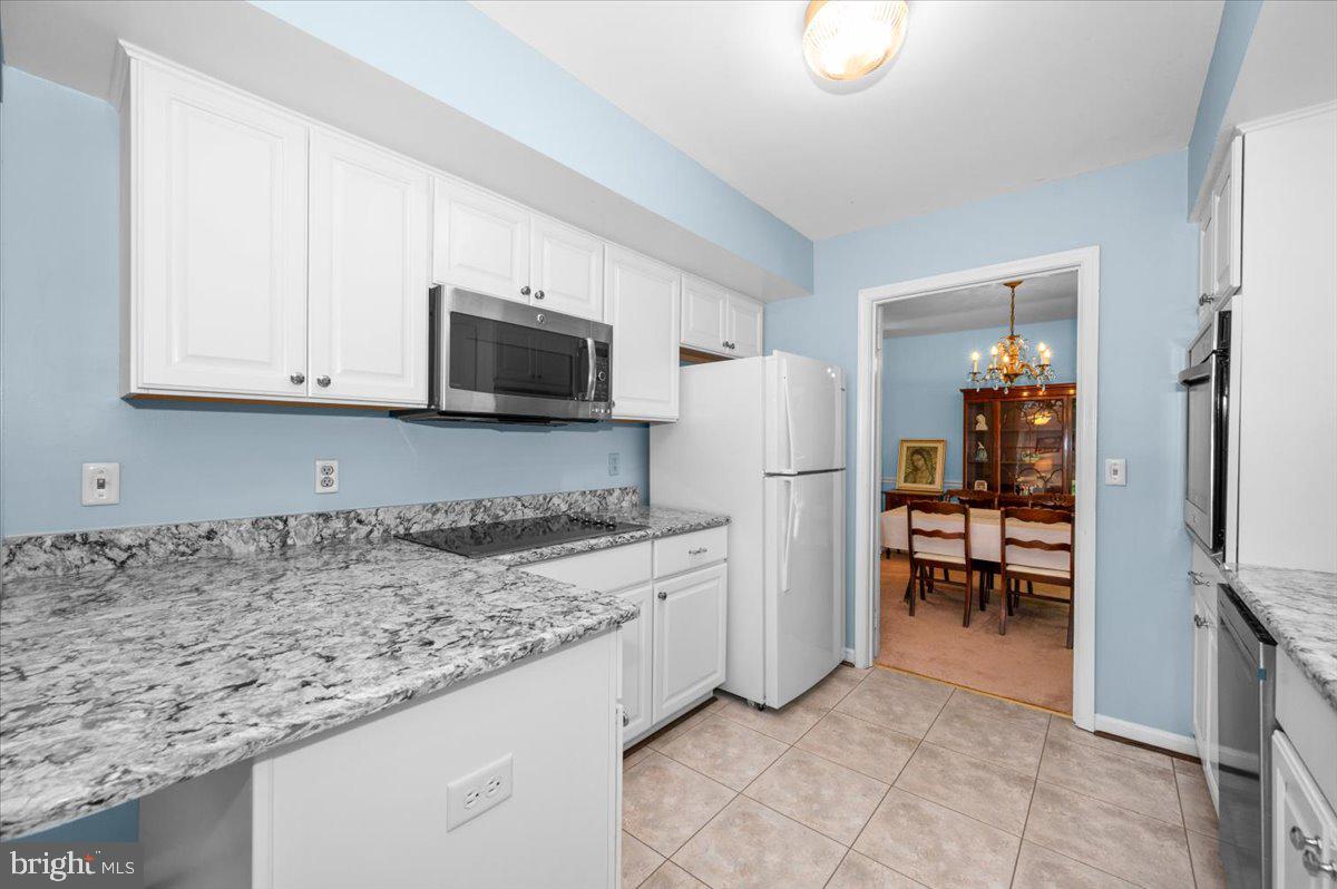2614 Apple Way Dunkirk, MD 20754 - Photo 11 of 54 a kitchen with stainless steel appliances granite countertop a refrigerator stove and microwave