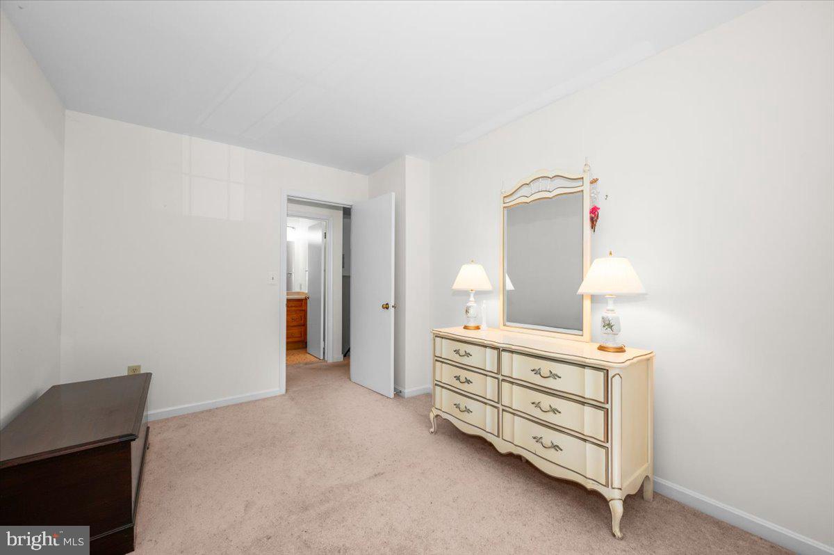 2614 Apple Way Dunkirk, MD 20754 - Photo 24 of 54 a spacious bedroom with a bed and a lamp on desk