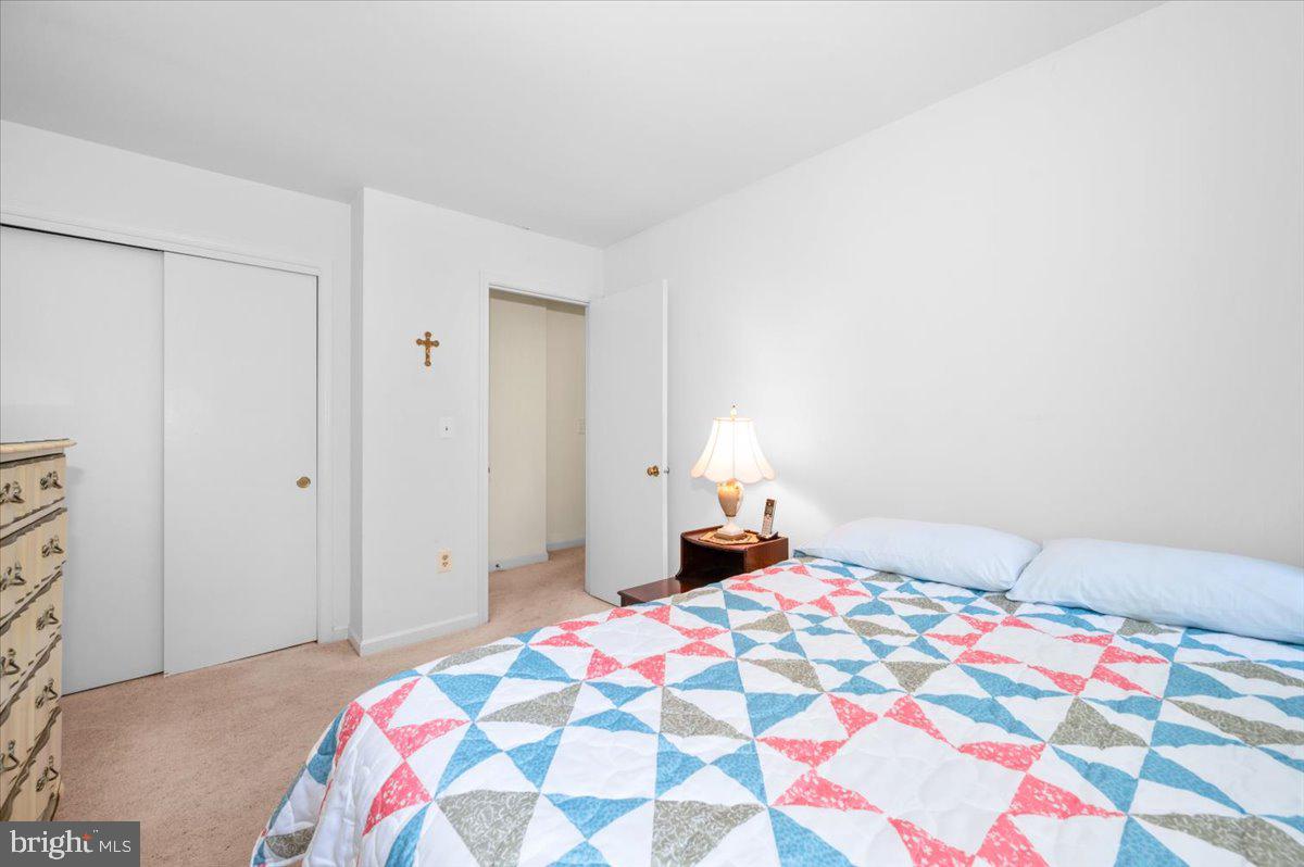2614 Apple Way Dunkirk, MD 20754 - Photo 26 of 54 a bedroom with a bed and a lamp on dresser