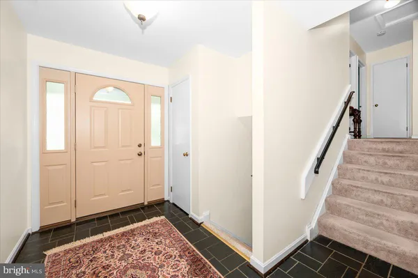 a view of a hallway with wooden floor and entryway