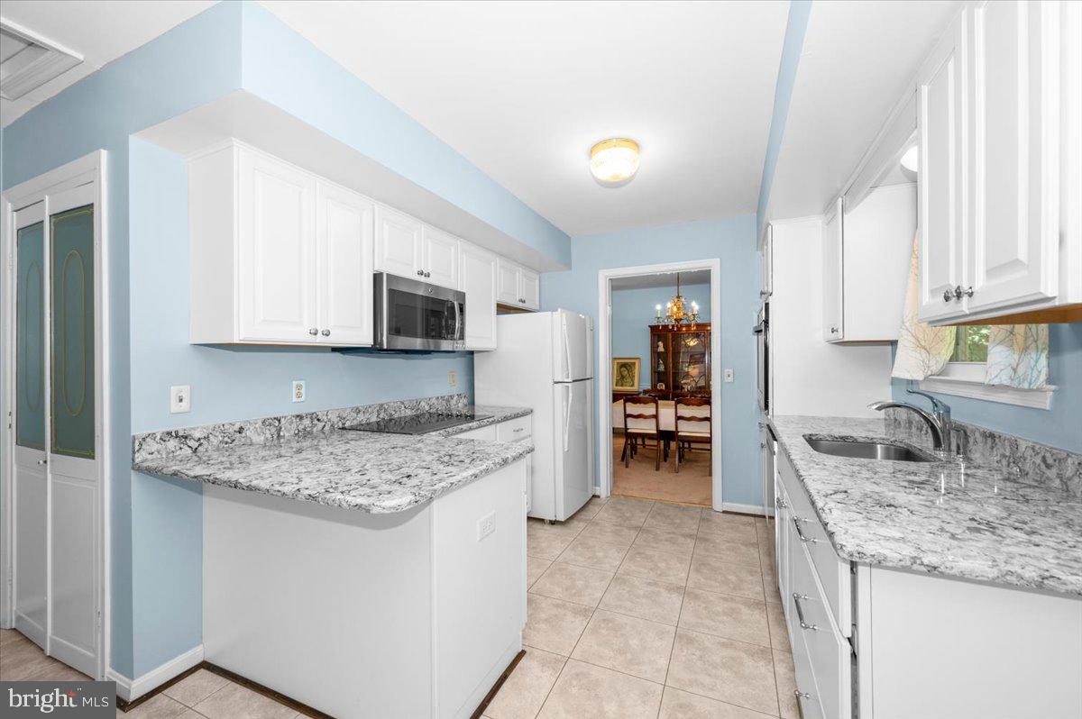 2614 Apple Way Dunkirk, MD 20754 - Photo 10 of 54 a kitchen with stainless steel appliances granite countertop a sink stove and refrigerator