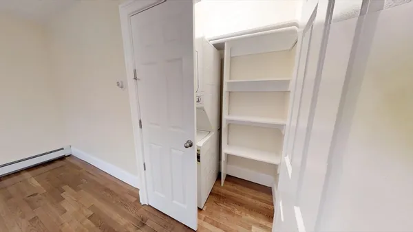 a view of a room with wooden floor