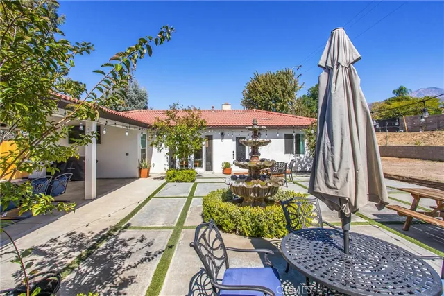 a living room with furniture kitchen view and a wooden floor