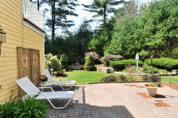 41 Forest Street Sherborn, MA 01770 - Photo 27 of 30 a view of a chair and table in backyard of the house